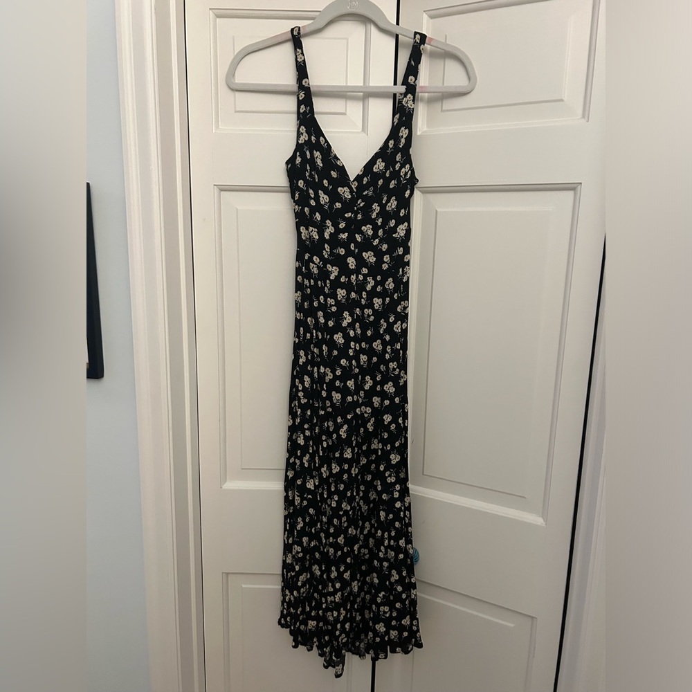 Adorable black floral midi dress with cute open back / bow detail!